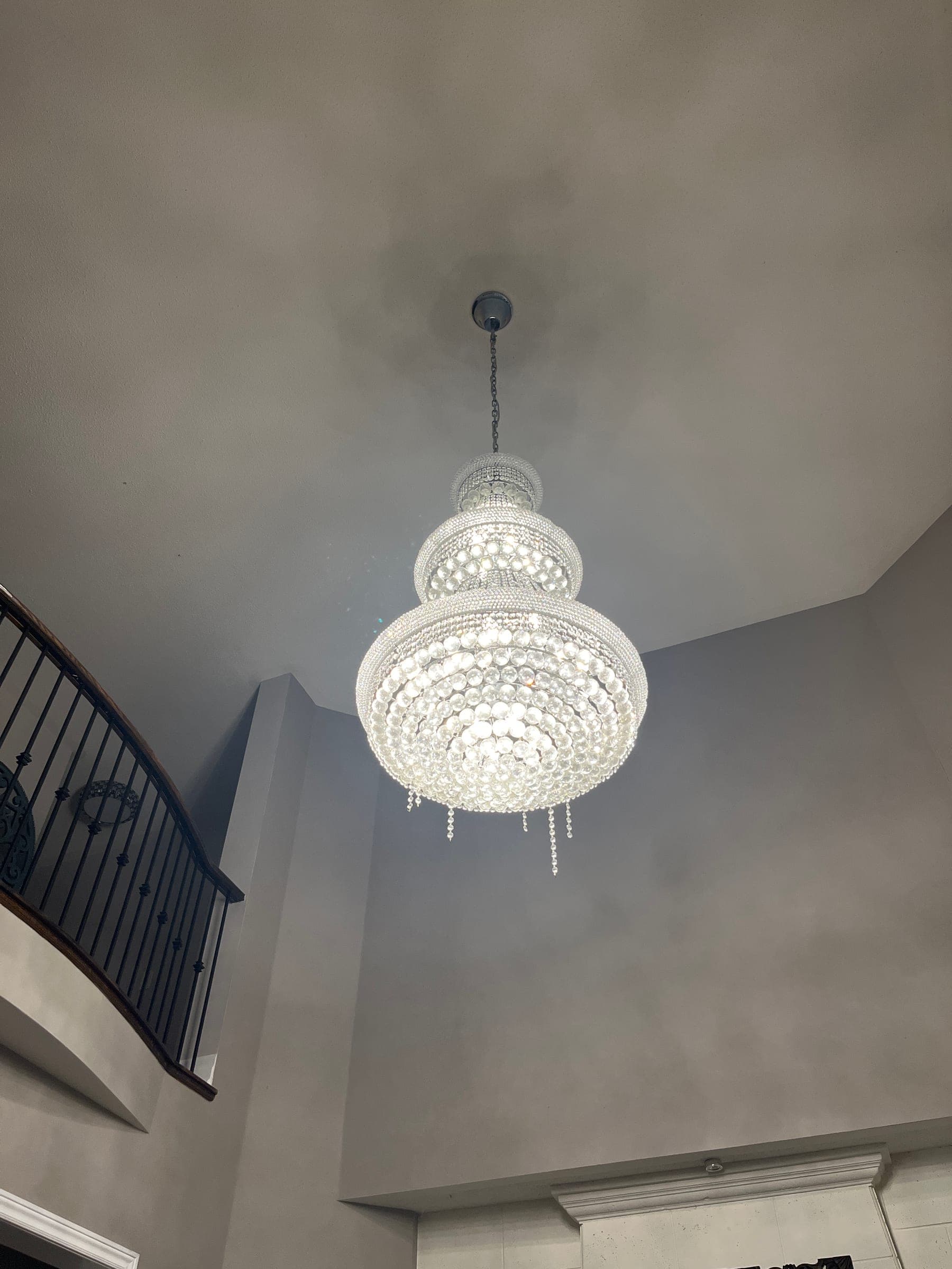 Chandelier before cleaning, dusty with loose crystals