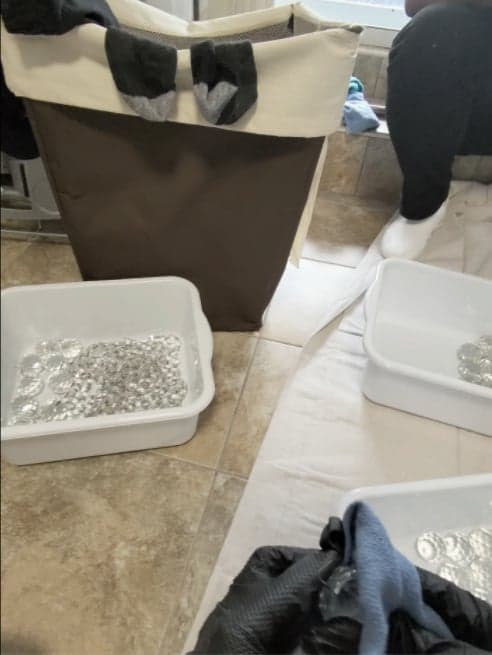 Chandelier crystals soaking and being hand-washed