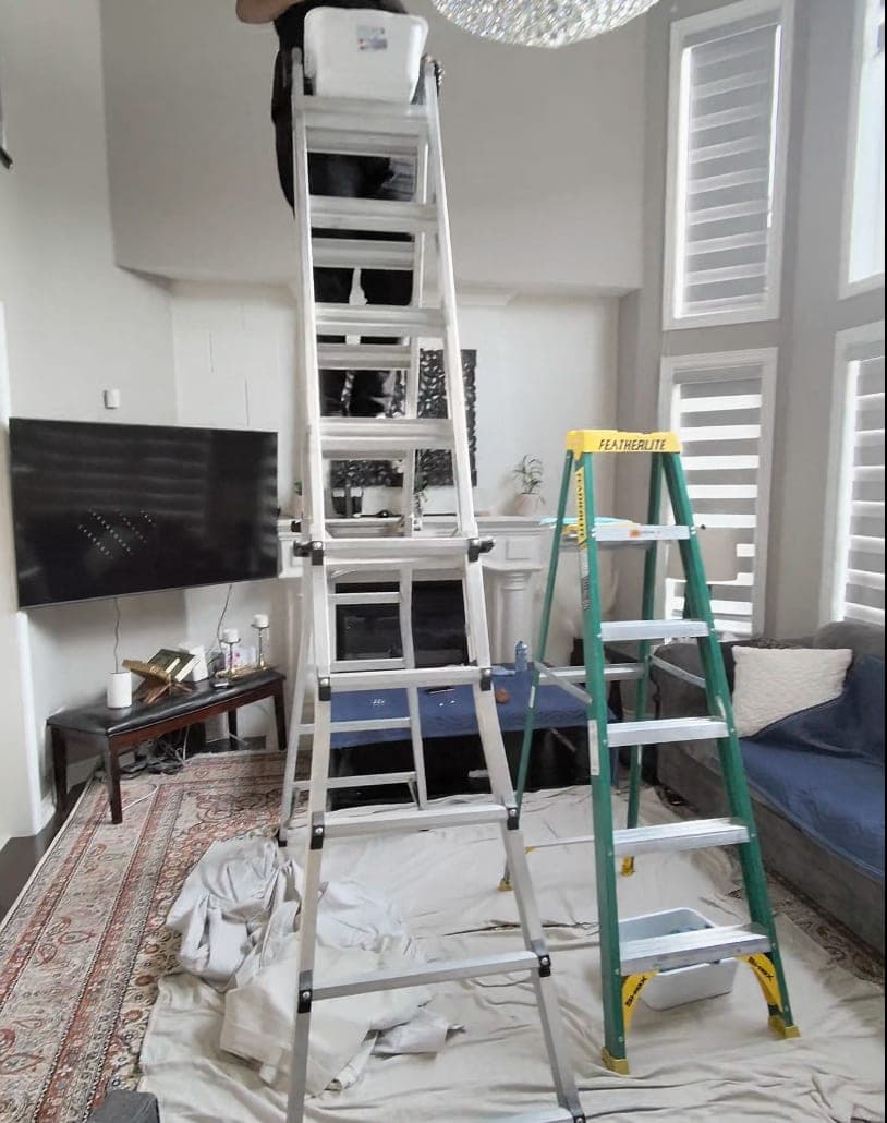 Ladders and drop sheets set up to protect the room before cleaning