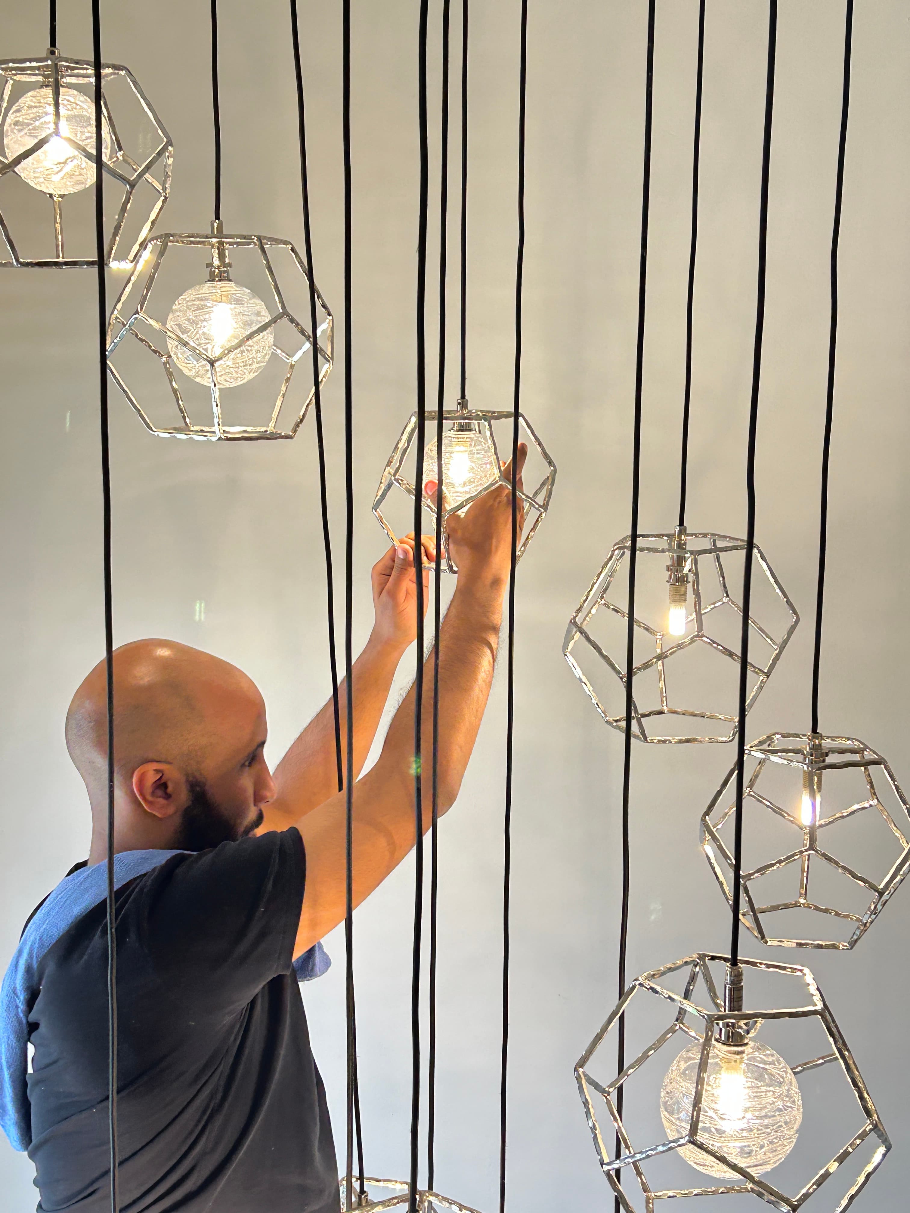 Hand-polishing geometric pendant lights